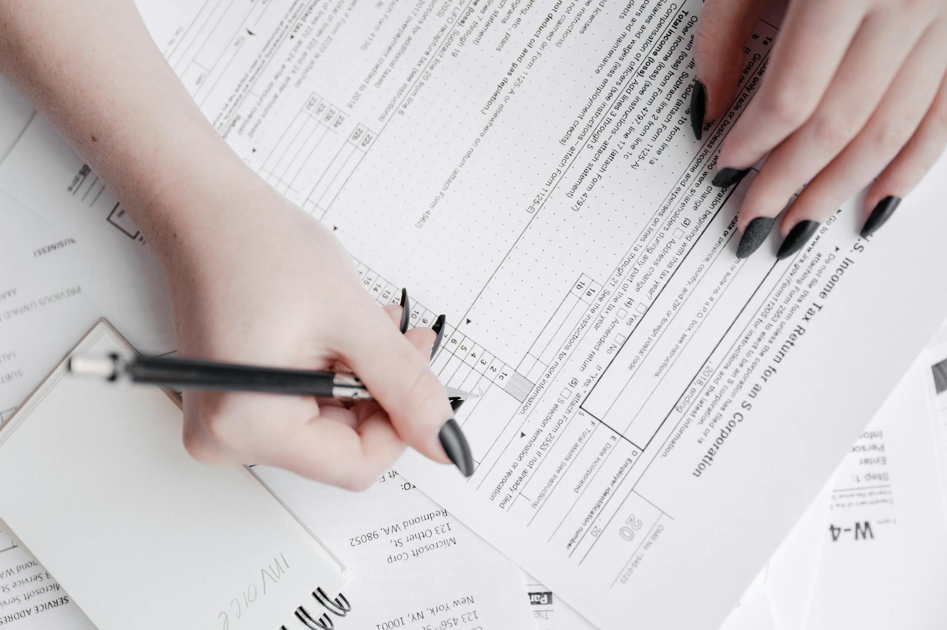 Female Hands Writing on Documents