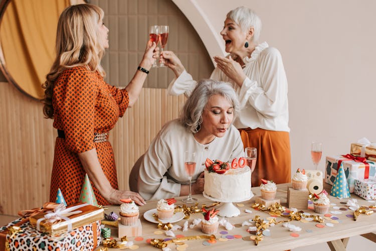 A Group Of Elderly Women Celebrating A Birthday Together