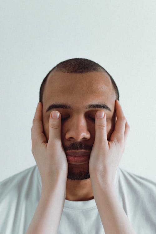 A Person Covering a Man's Eyes