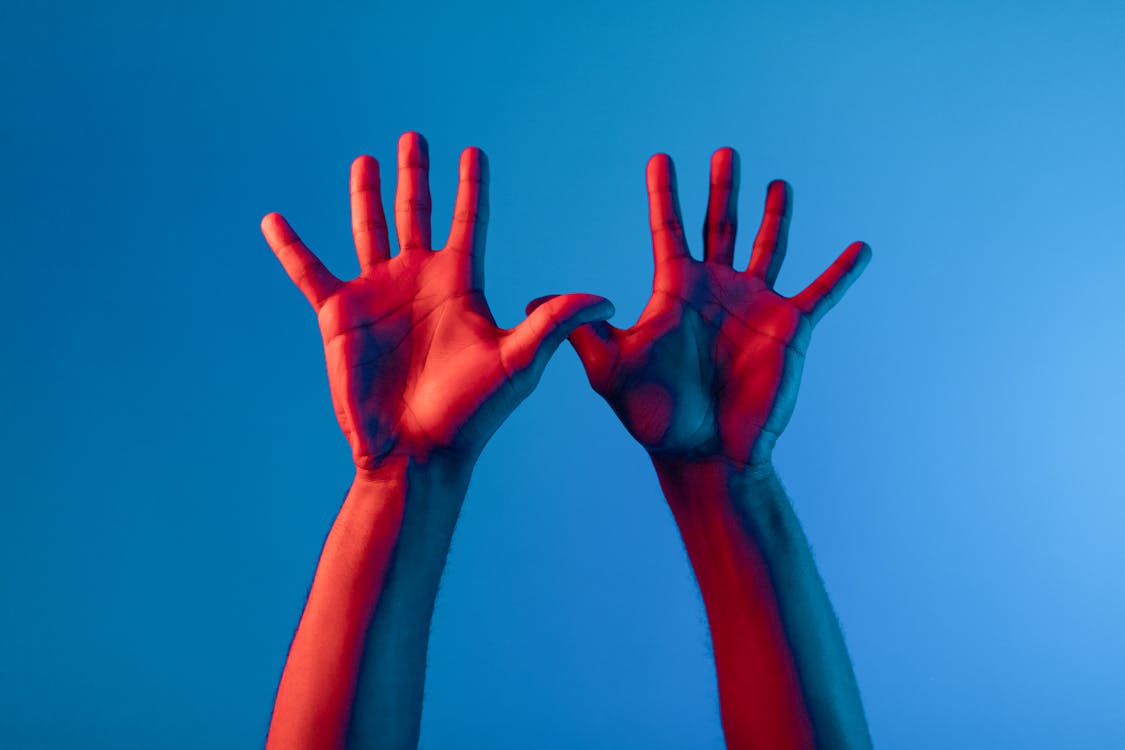 Free Persons Hand With Red Paint Stock Photo