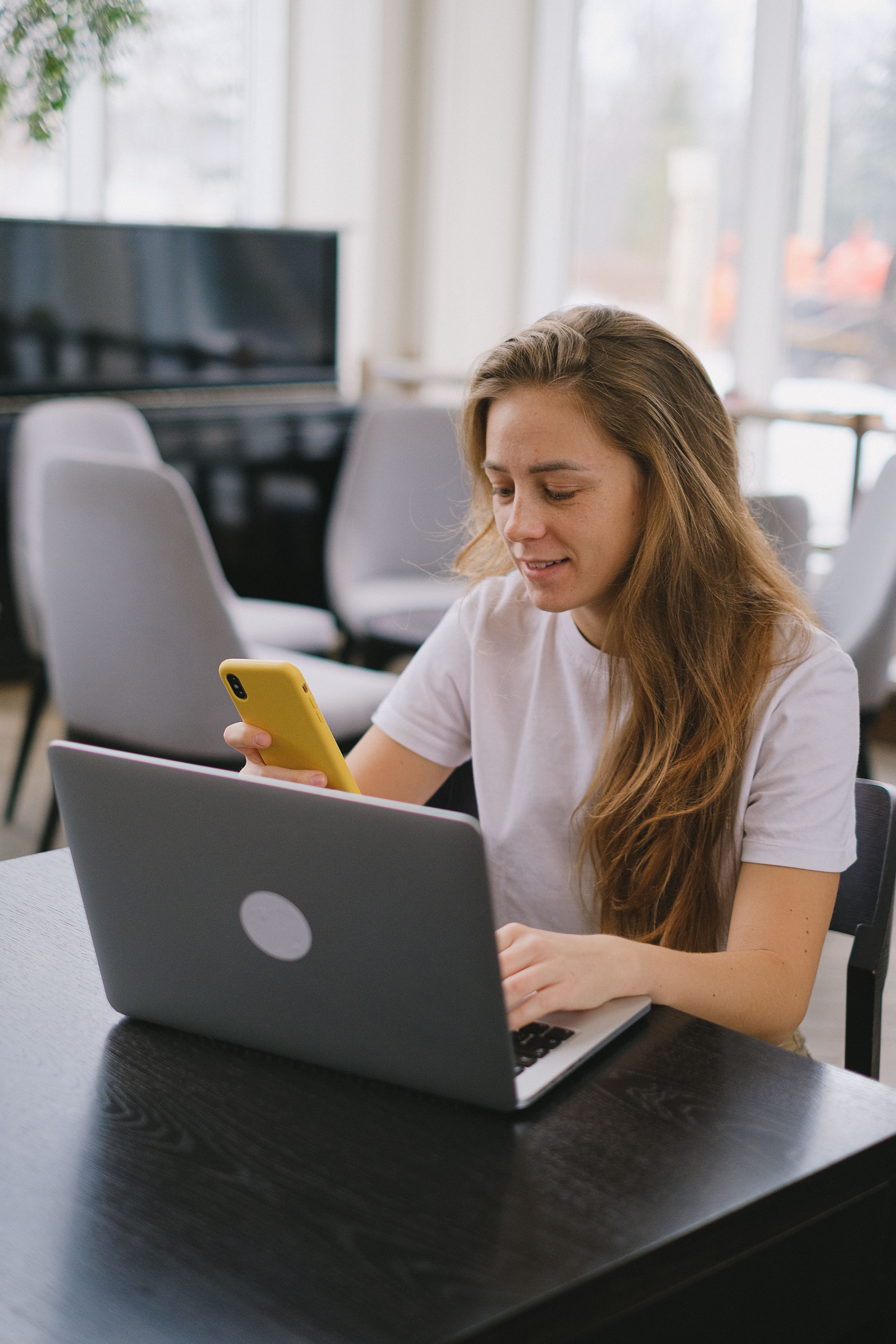 Focused woman working on laptop · Free Stock Photo