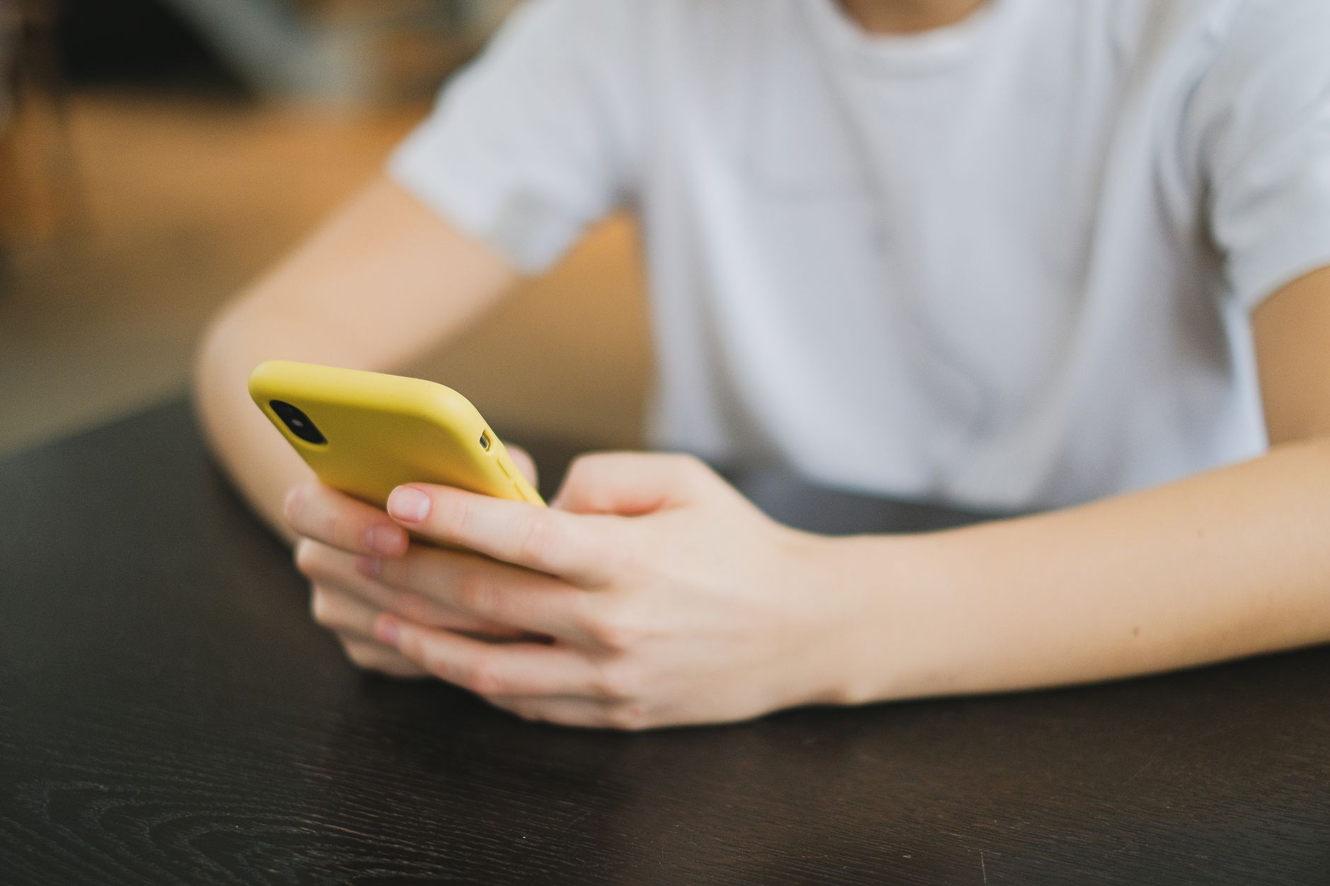 A person holding a phone in a kitchen in the morning, the four-second moment a daily habit gets ticked