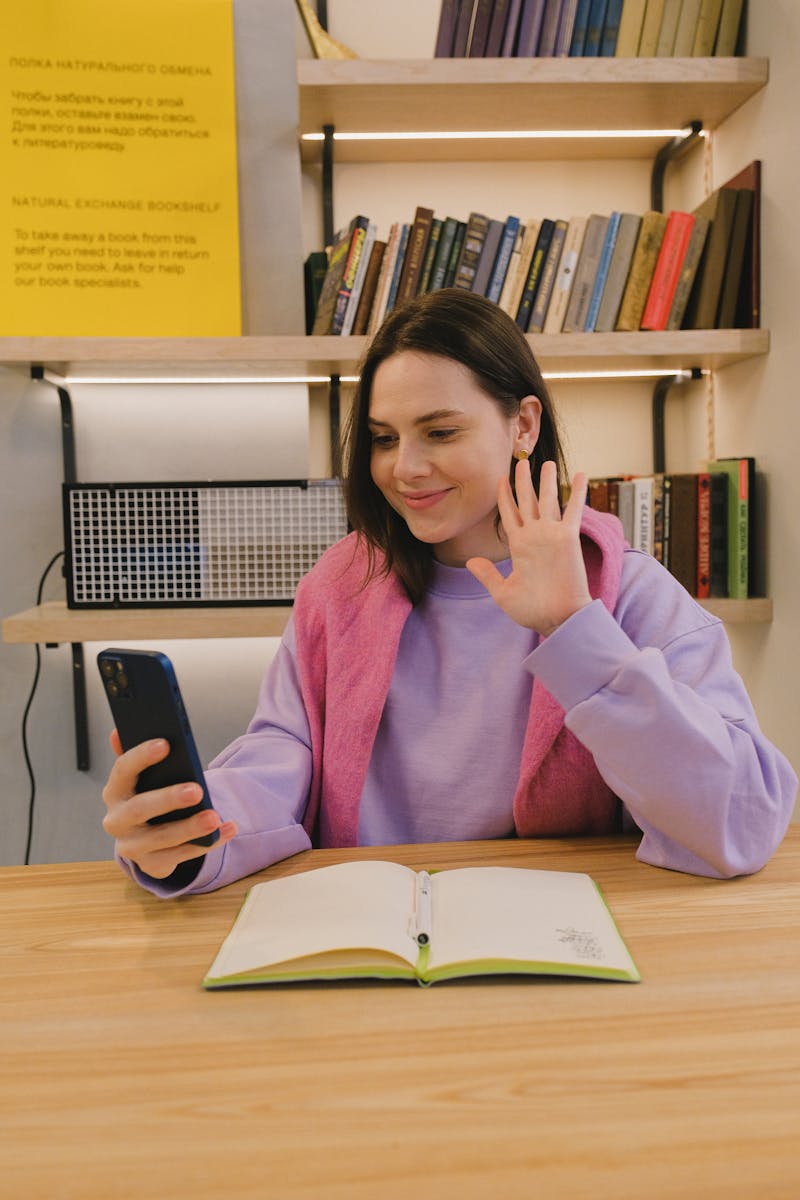 Woman in Pink Sweater Holding Smartphone