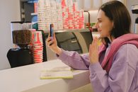 Girl in Pink Long Sleeve Shirt Holding Blue Pen