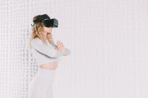 Woman with a VR Headset Practising Yoga 