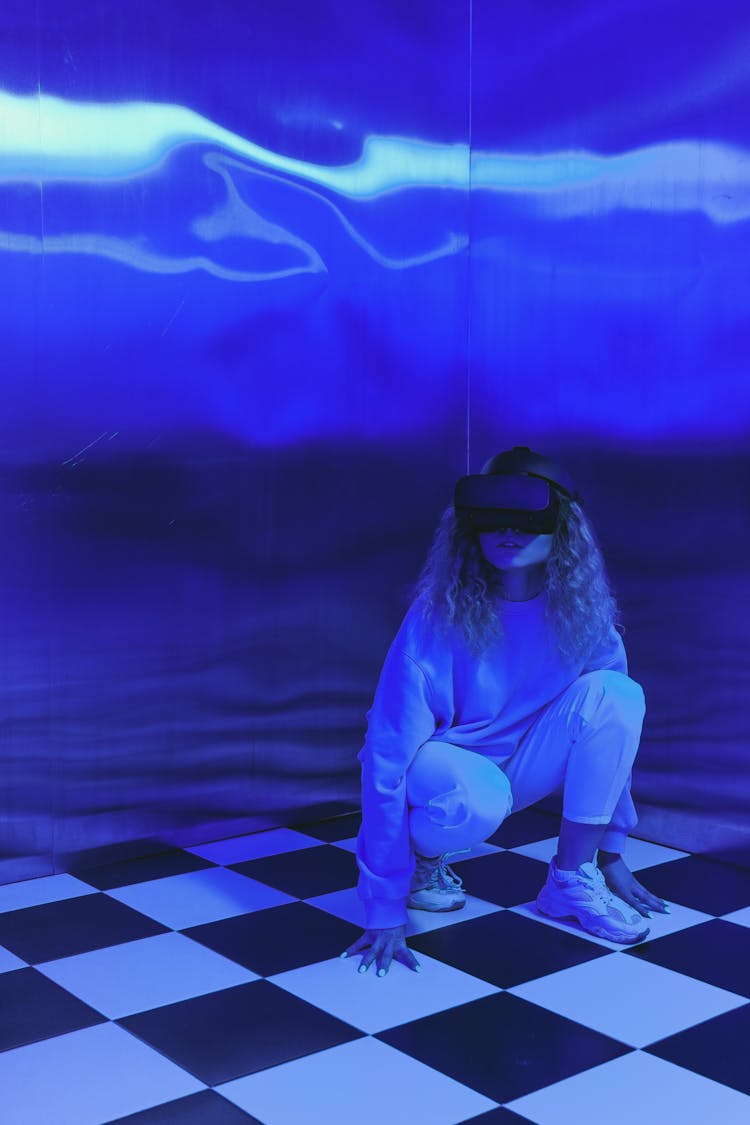 Woman Crouching With VR Goggles