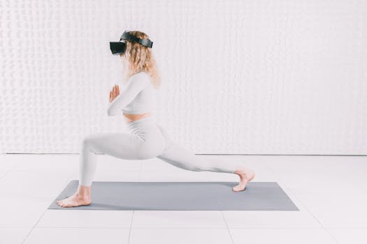 Adult woman in yoga pose wearing VR headset, exploring virtual reality indoors on a mat.