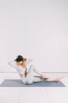 Woman performing exercise with VR goggles on a mat in sleek indoor space. Innovative fitness concept.
