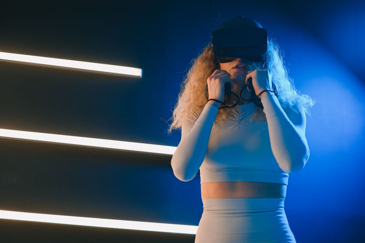 Player in a VR headset under blue light