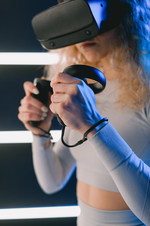 Woman Using Virtual Reality Headset and Controllers