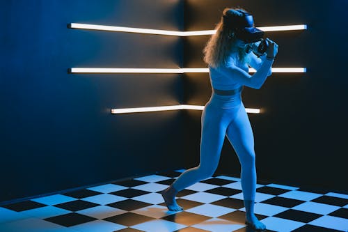 A Woman Using a Virtual Reality Headset in a Dark Room