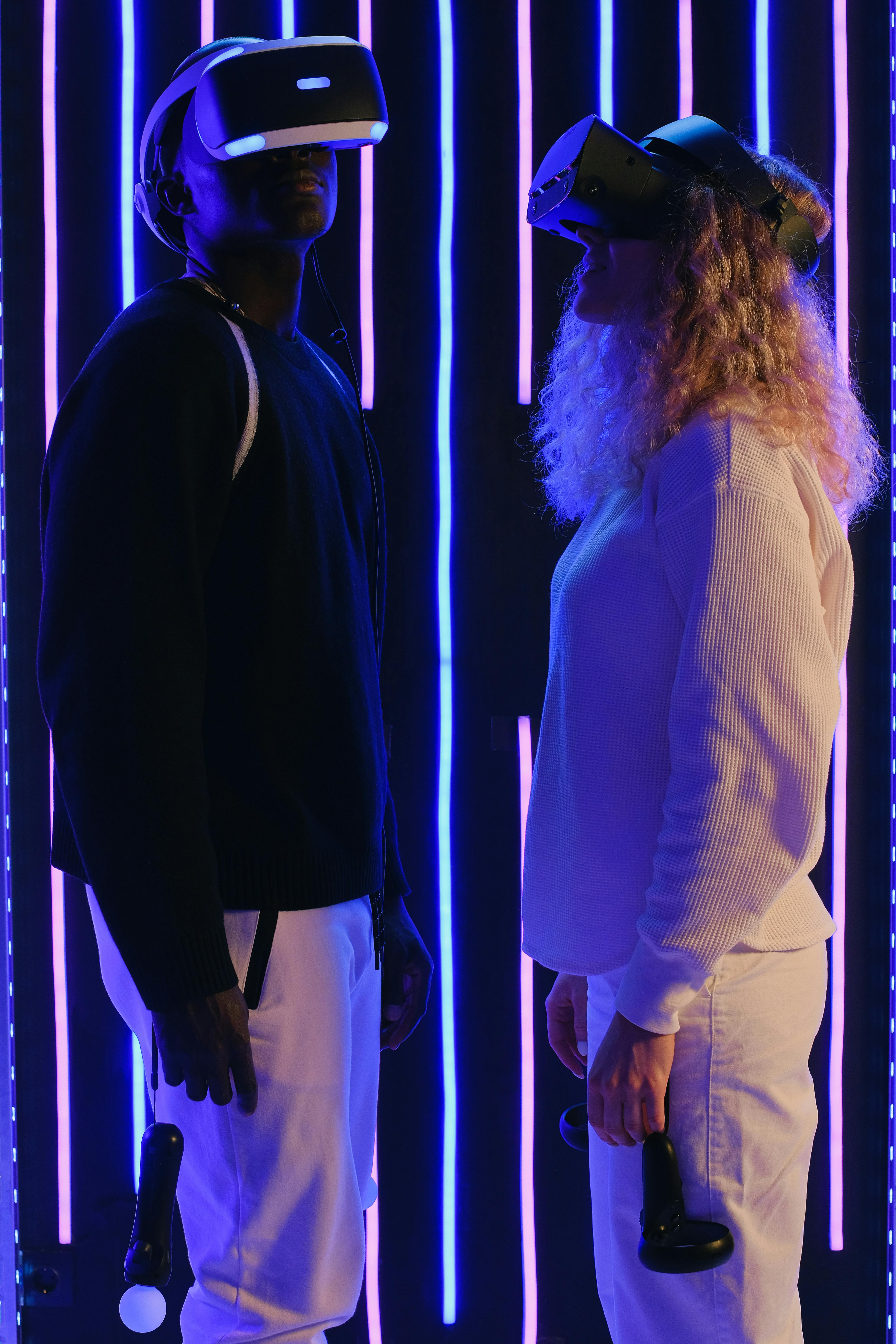 couple in vr glasses in dark illuminated room