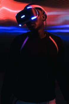 Portrait of an African American man wearing a VR headset, illuminated by neon lights.
