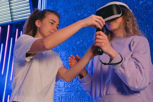 Two women exploring virtual reality with a headset and controller in a tech-themed setting.