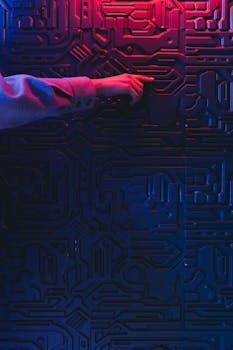 A person's hand interacting with a glowing circuit board, creating a modern tech ambiance.