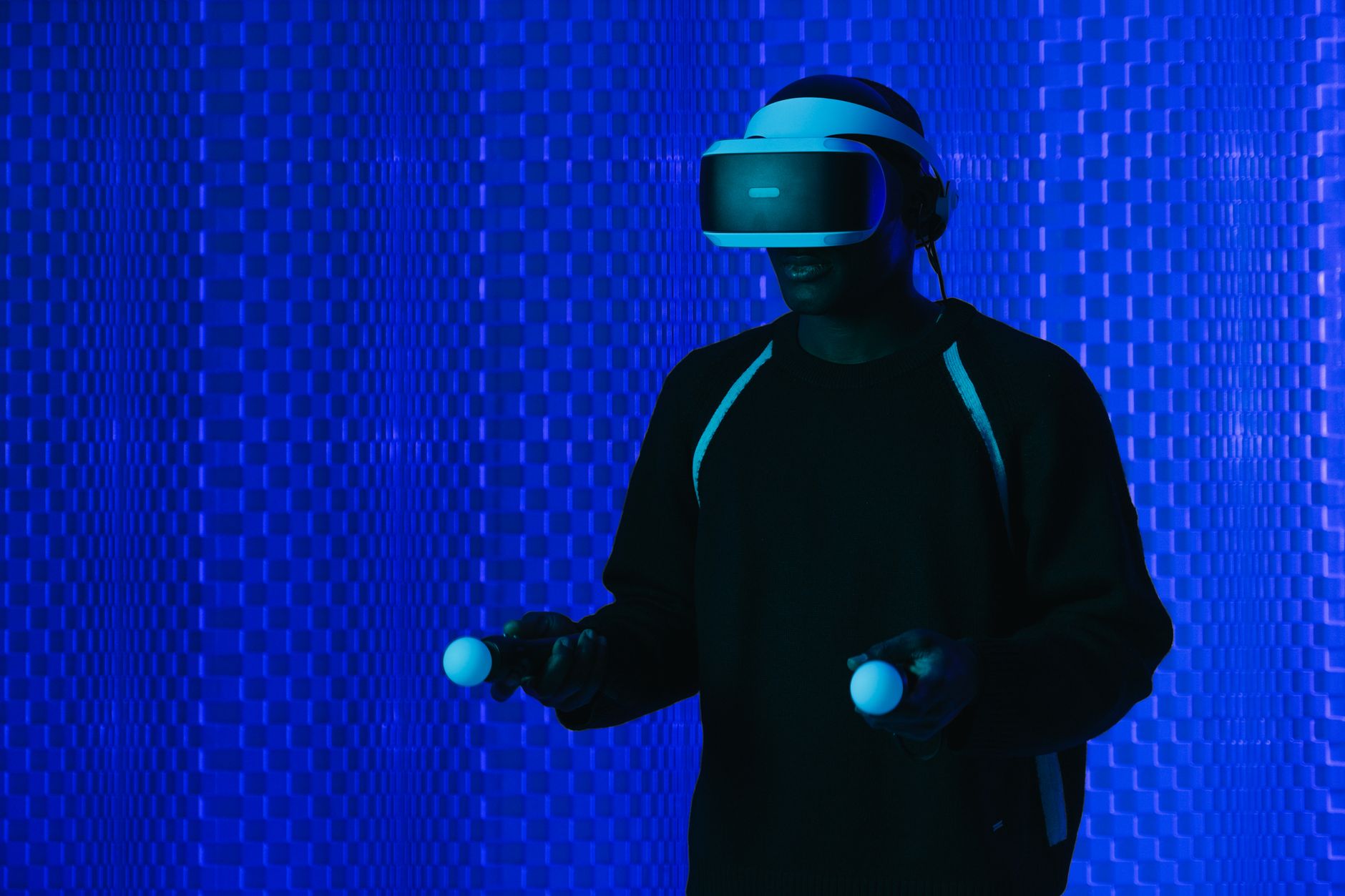vr games rental for events egypt — A man wearing a VR headset and using controllers immersed in a futuristic setting.