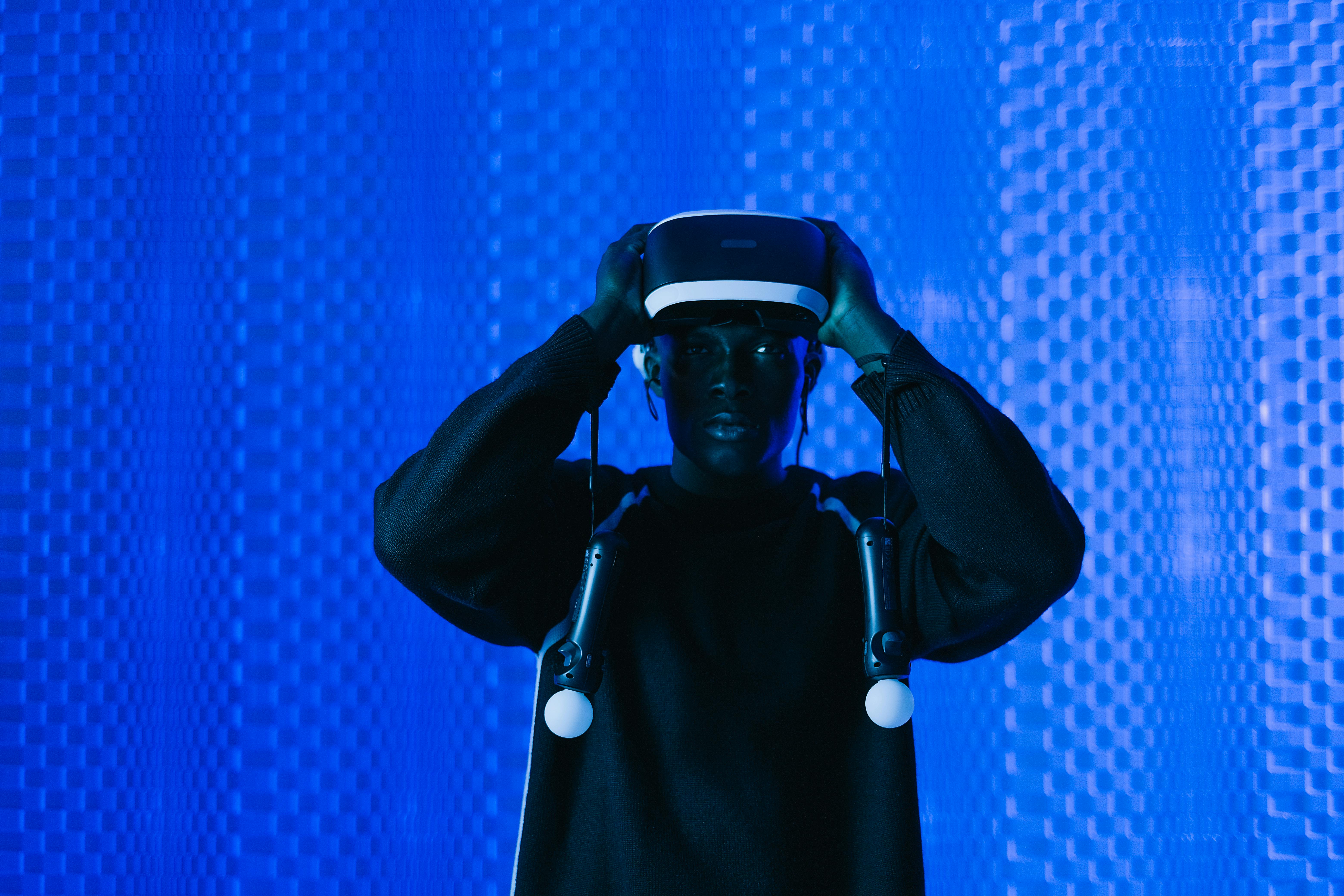 man with virtual reality headset and controllers