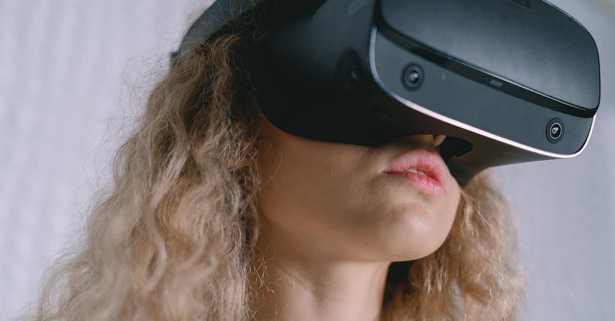 A young woman with curly hair using a VR headset, experiencing virtual reality.