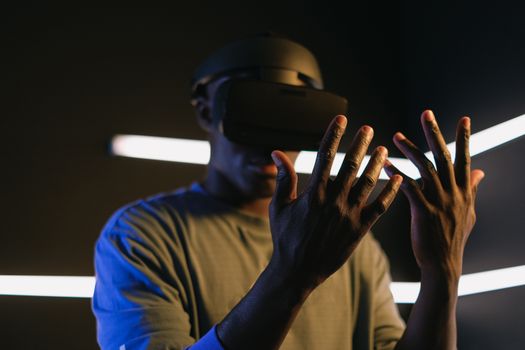 Focused view of a person using VR goggles and exploring virtual reality. Captures modern technology theme.