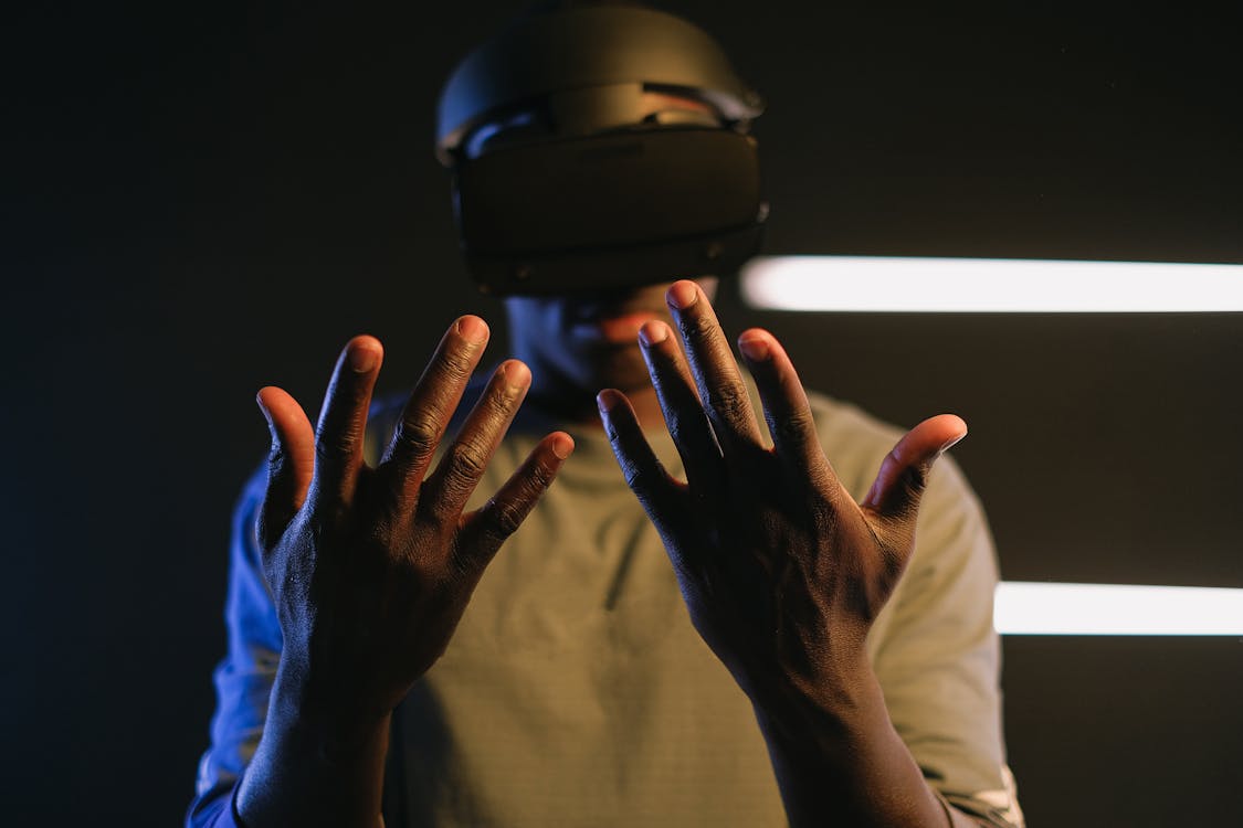 A Man Looking at His Hands Using a Vr Goggles