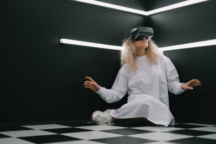 Woman In VR Glasses In Black Room