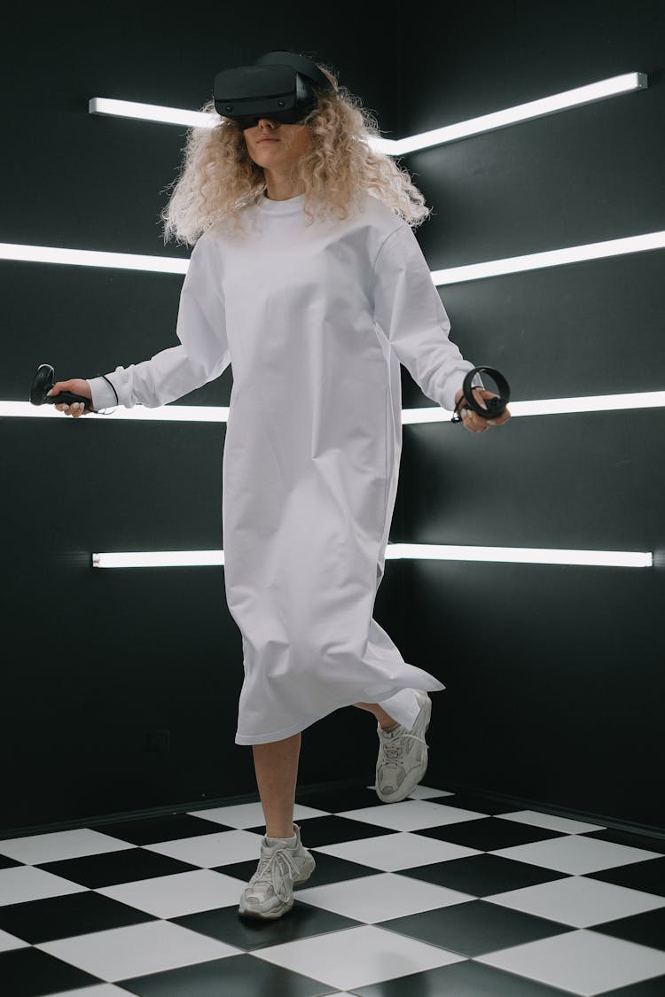 Woman Playing In Room With VR Goggles