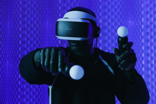 Experience virtual reality gaming with advanced VR headset and controllers in a vivid blue setting.
