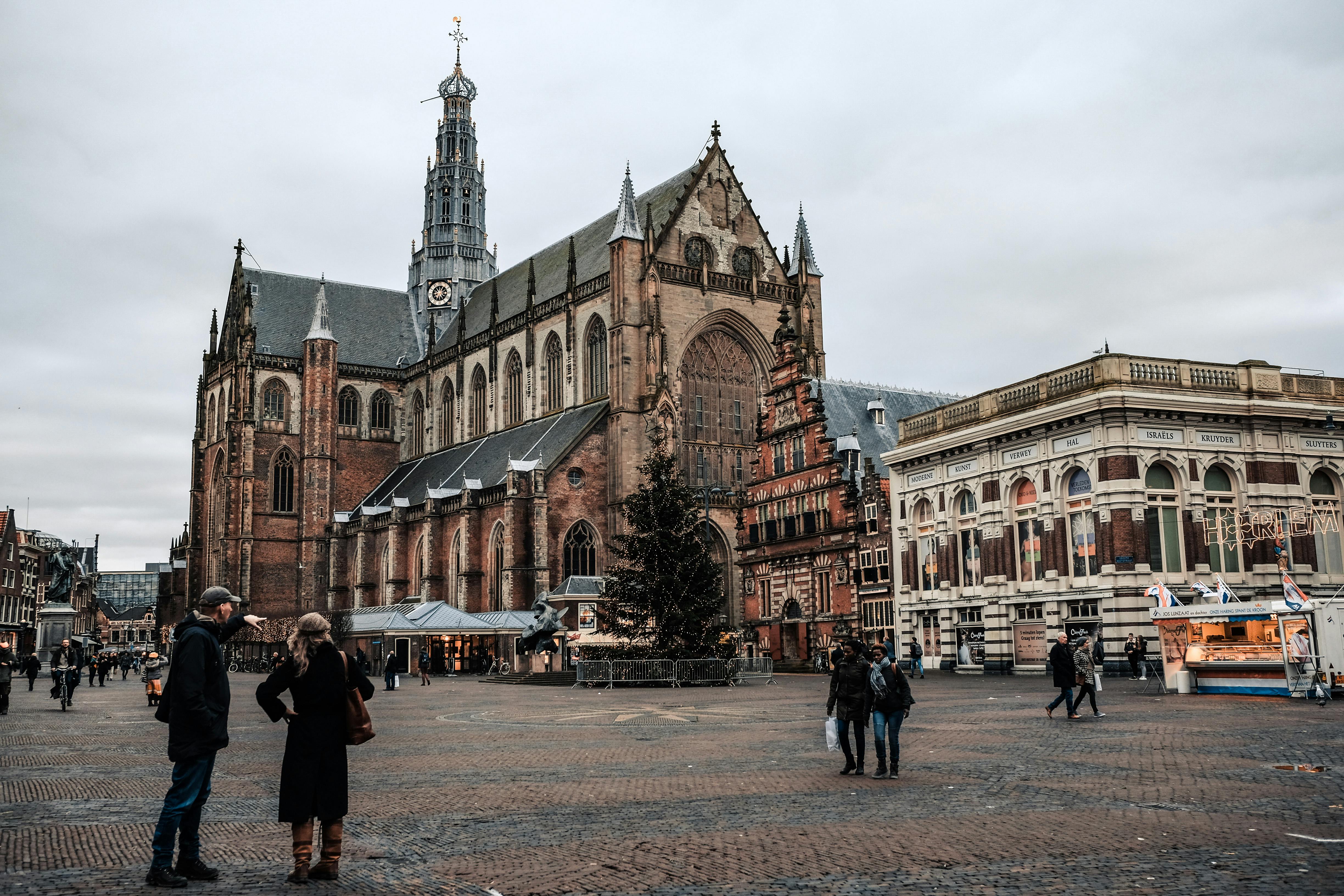 Scenic view of a historic church and lively square in Haarlem, Netherlands.