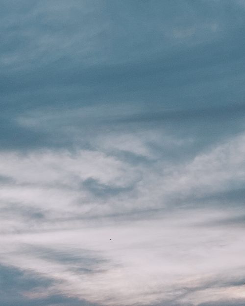 Free Tranquil view of a serene cloudscape with soft blue and white tones in an expansive sky. Stock Photo