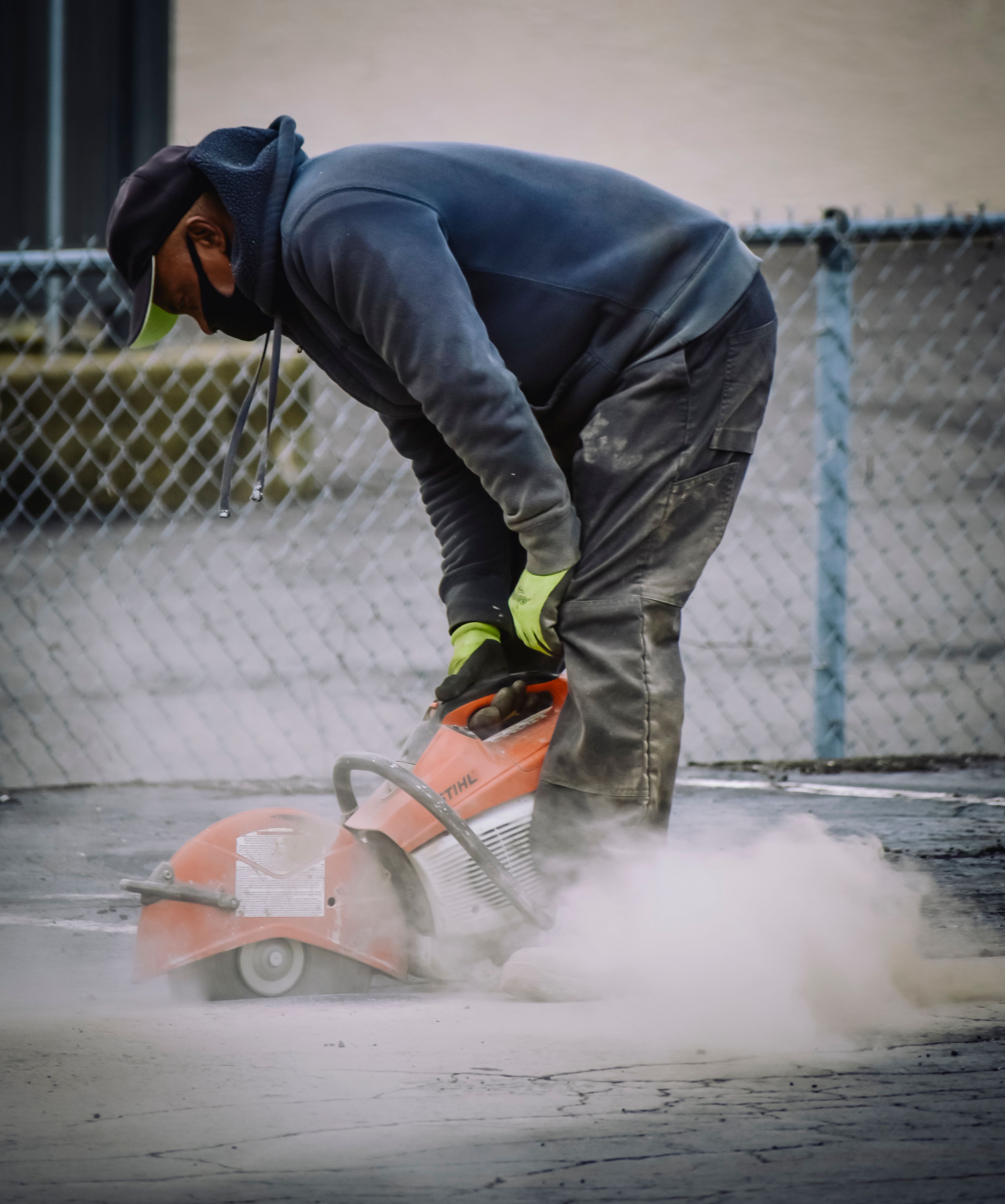 Do You Need a QBCC Licence for Fencing? Rules, Exemptions & Licence Classes Explained 7 Worker with protective gear cutting materials outdoo rs