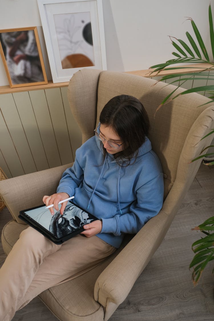 A Woman Drawing On A Digital Tablet