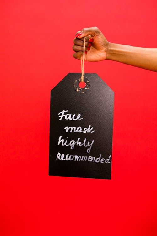 A Person Holding a Hanging Signage