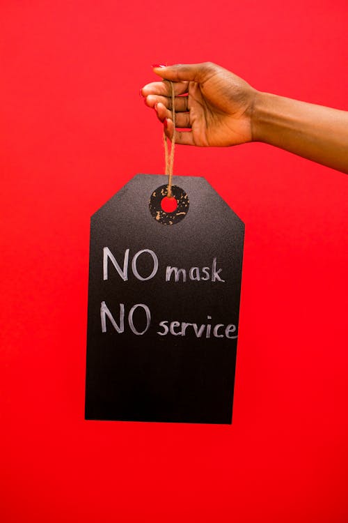 A Person Holding a Hanging Signage