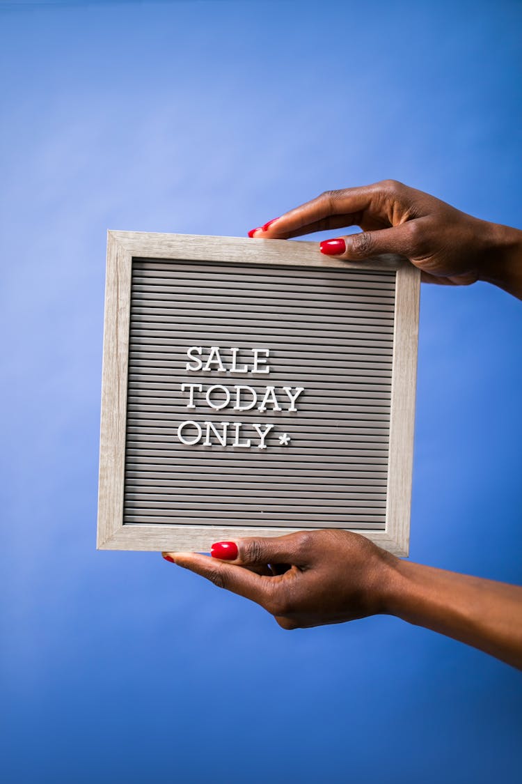 A Person Holding A Letter Board