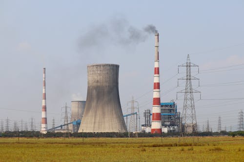 Free View of a Power Plan with Smoke Coming Out of the Chimneys Stock Photo