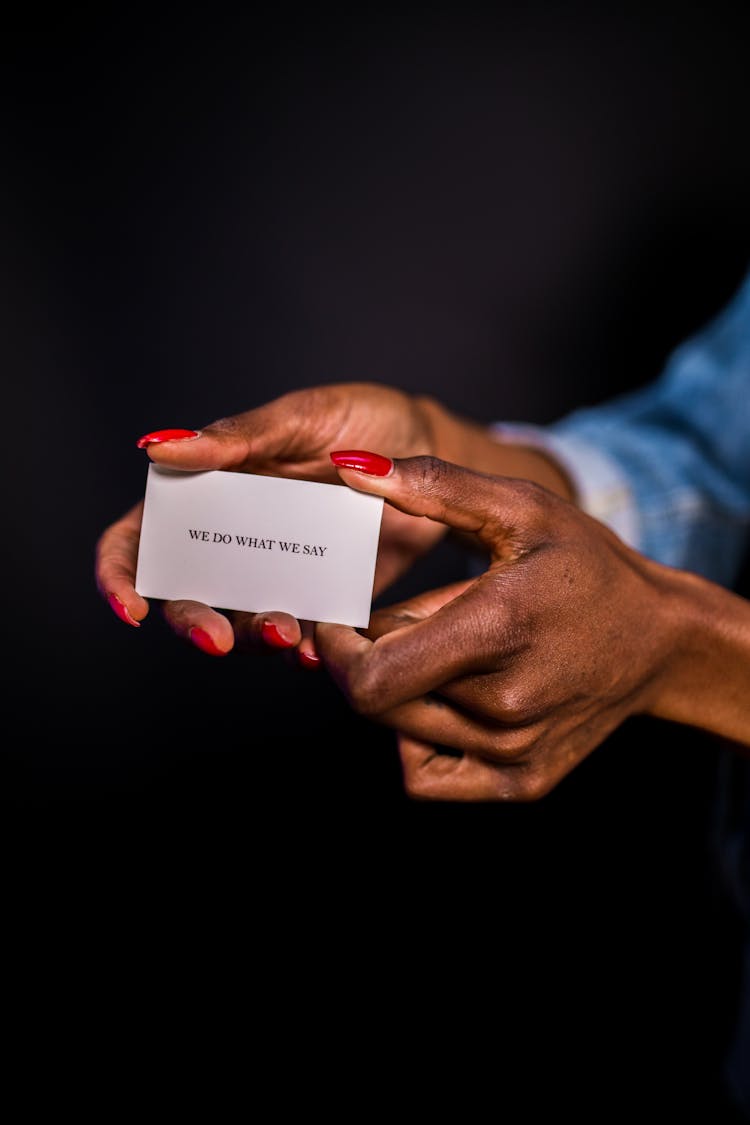 Close-up Of Woman Holding A Business Card 