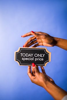 Close-up of hands holding a special price sign, ideal for marketing use.