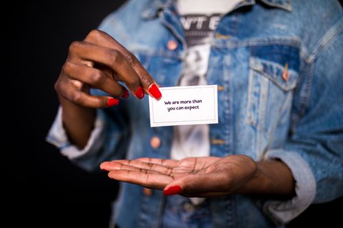 Free Woman holding a card with an inspiring message about expectation. Stock Photo