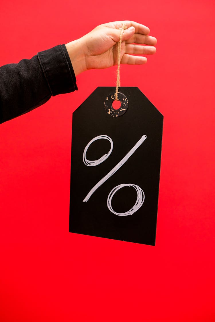 Person Holding A Chalkboard With A Percentage Sign 