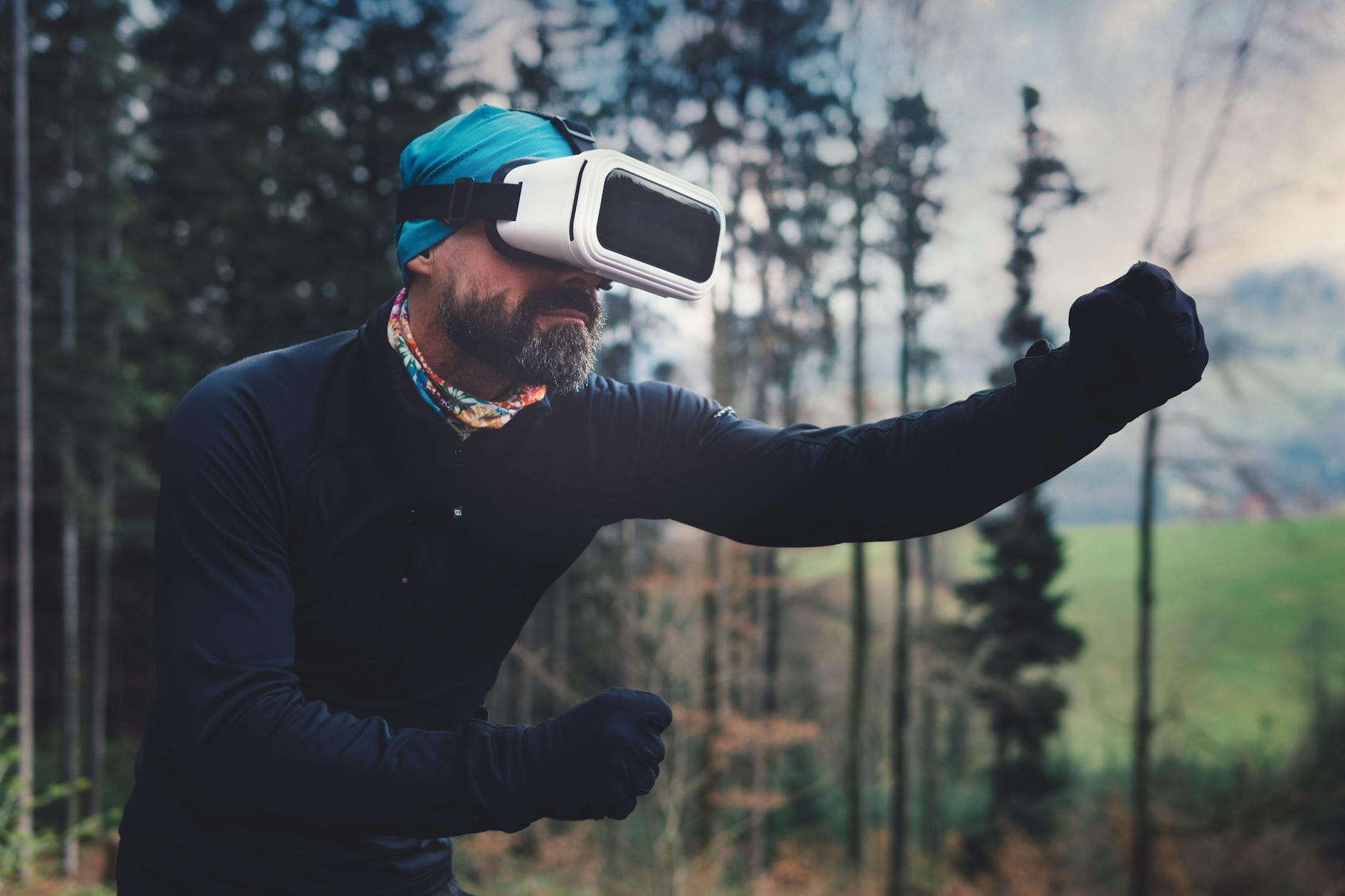 Man in the forest is playing a VR game