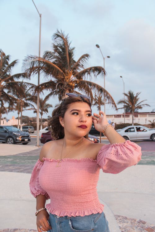 A Pretty Woman in Pink Off Shoulder Top Posing