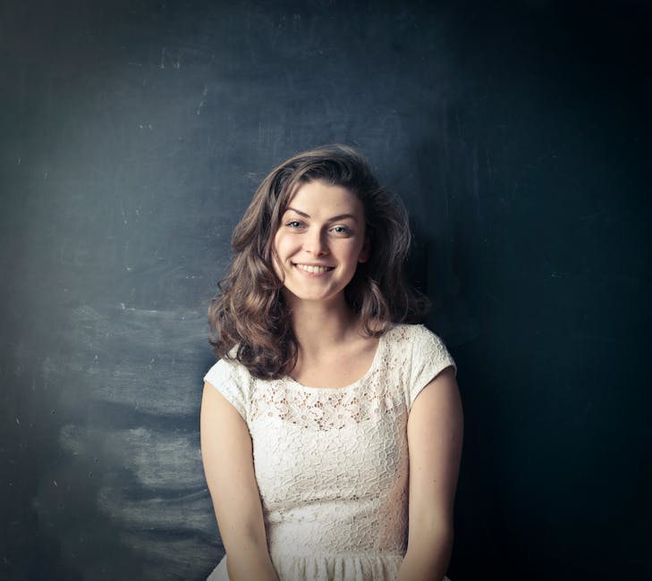 Brown Haired Girl in White Sleeveless Dress Standing Beside Black Painted Wall