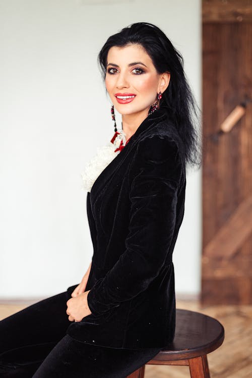 A Beautiful Woman in Black Blazer Sitting on a Chair