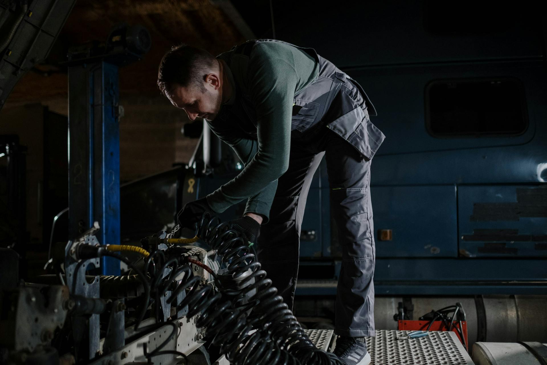 Man Repairing a Truck in a Car Service Shop