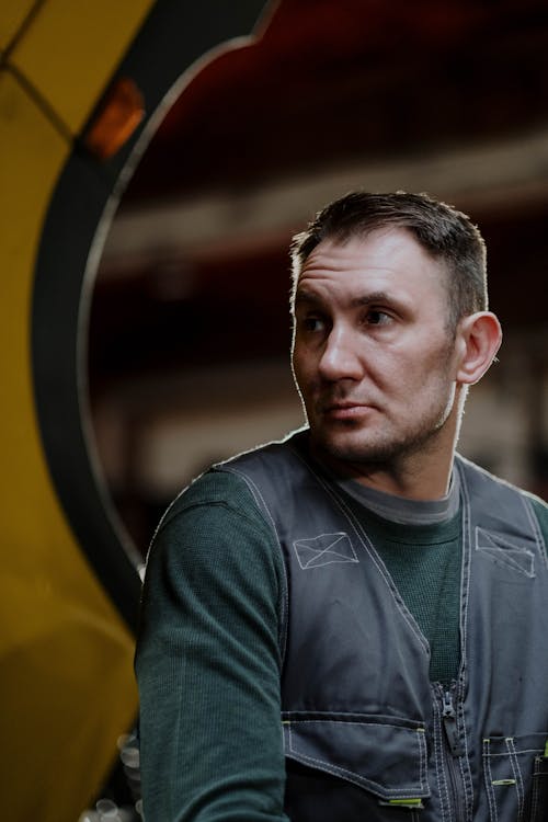 Close-Up Shot a Man Wearing a Gray Vest