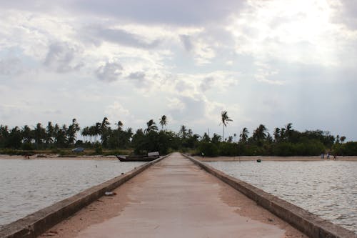A View of a Beach from a Concrete Pier