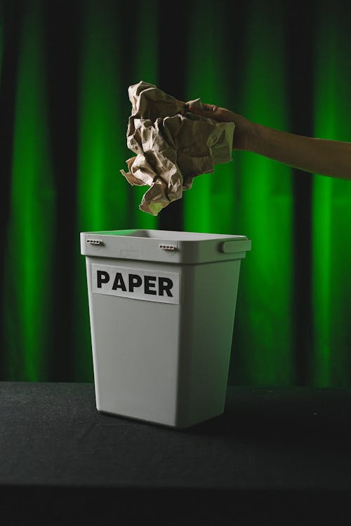 
A Person Throwing a Crumpled Paper in the Trash