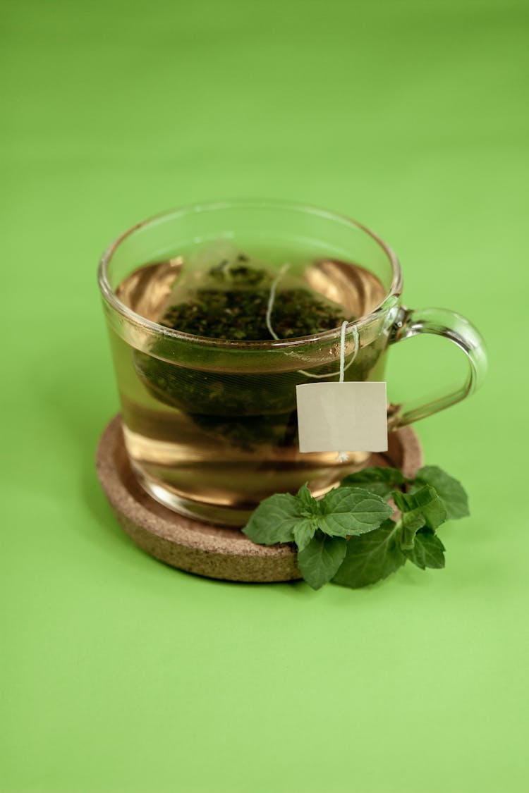 Green Tea On Cup Holder With Mint Leaves