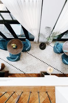 Bright and stylish overhead shot of a modern café with elegant furniture and decoration.