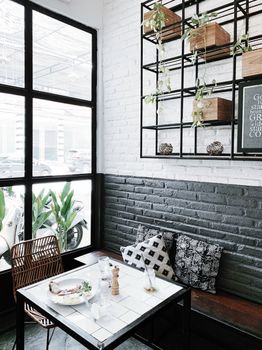 Chic café scene featuring contemporary industrial interior design and décor, with a stylish dining setup.